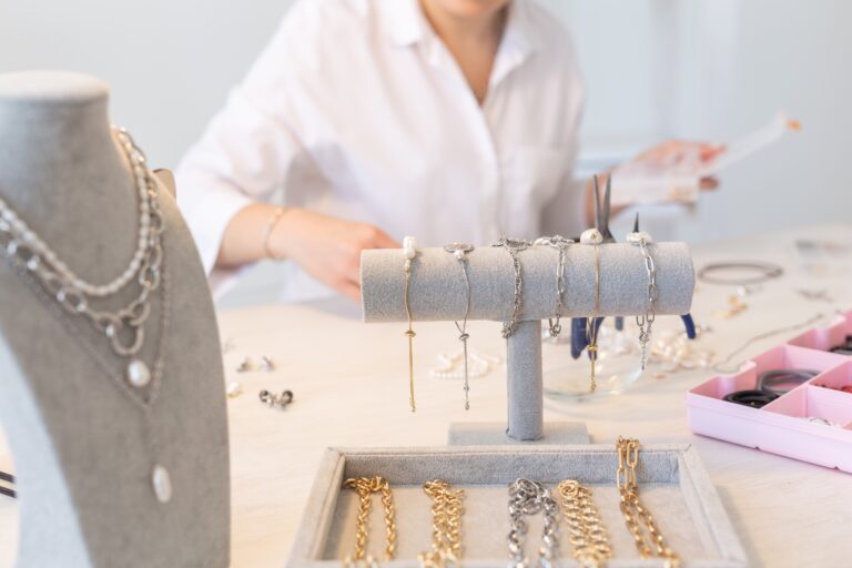 Professional jewelry designer making handmade jewelry in studio workshop close up. Fashion